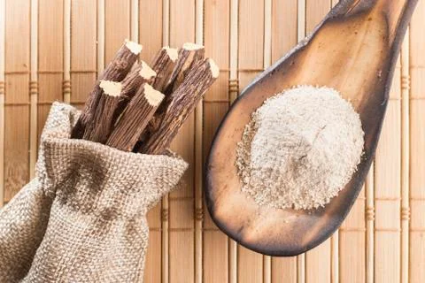 Powder and licorice root on the table - Glycyrrhiza glabra Stock Photos