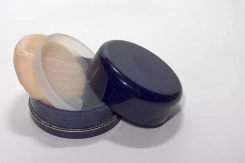 Powder boxes, closed and half-open, with sticking out powder puff. Still life Stock Photos