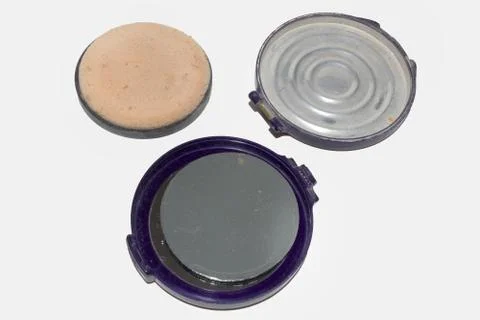Powder case, broken in half at the loop and disassembled apart. Isolated Stock Photos