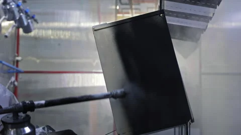 Powder coating application on metal panel, spray gun disperses even layer Stock Footage 311075145
