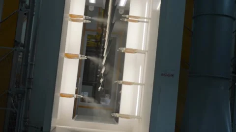 Powder coating line with automated sprayers coating metal frames Stock Footage 322183077