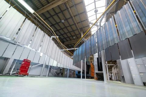 Powder coating line. Metal panels are suspended on an overhead conveyor line. Stock Photos