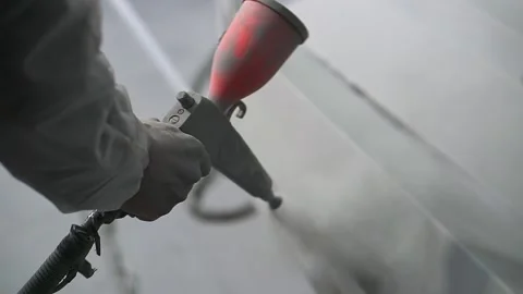 Powder coating. Man's hand with spray gun applies powder to metal object. Stock Footage 134730822