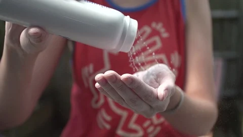 Powder falling onto hands in slow motion Stock Footage 86524119