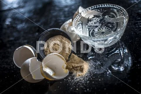 Powder or Ground egg shells with warm water used as a calcium supplement and Stock Photos