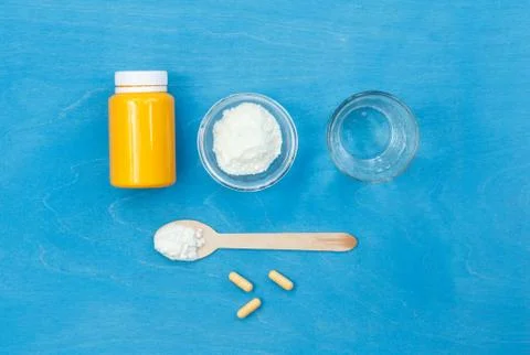 Powder for preparing the solution, a jar for pills, and a glass of water on a Stock Photos