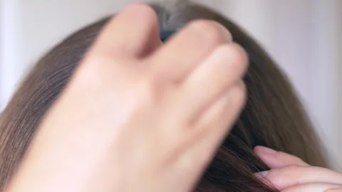 Powder sponge gently blends over gray hair roots, masking gray hairs and Stock-Footage 322617184