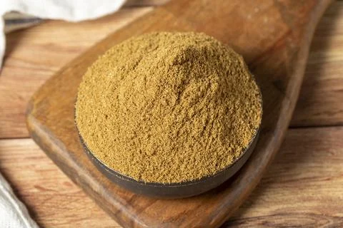 Powdered cumin spice. Cumin spice in bowl on wooden background. Dry spice con Stockfoto's