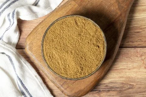 Powdered cumin spice. Cumin spice in bowl on wooden background. Dry spice con Stockfoto's
