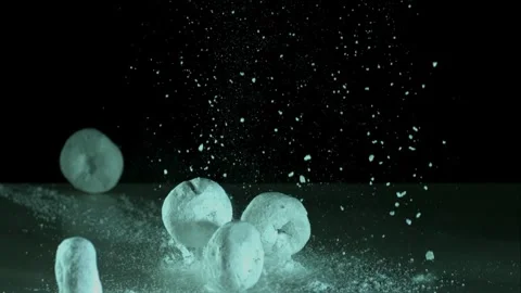 Powdered donuts falling on sugar covered surface Stock Footage 327180178
