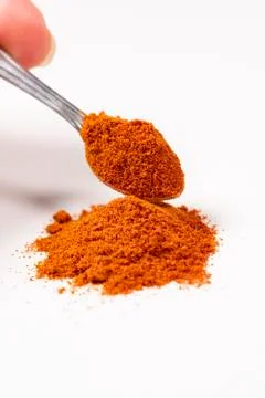 Powdered pimienta red pepper pile from top on white background Stock Photos
