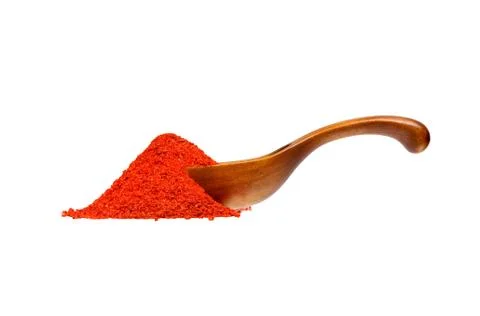 Powdered pimienta roja red pepper in the wooden spoon. Stock Photos