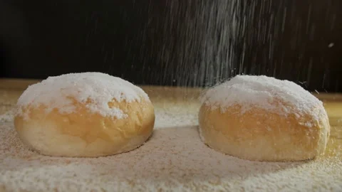 Powdered sugar is being sprinkled / dropping on freshly baked slices of bun Stock Footage 158977313