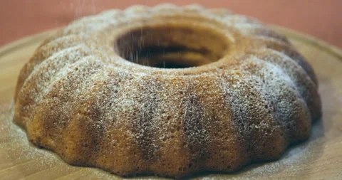Powdered sugar flies on pumpkin cake Stock Footage 220189797
