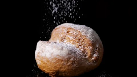 Powdered sugar or icing falling into sour dough roll Stock Footage 155890608