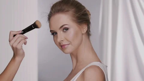 powdering pretty girl face with nude mak... | Stock Video | Pond5