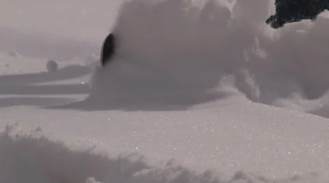 Powdery snow flies toward camera in slow motion in front of shovel. Video stock 47341444