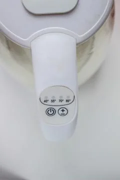 The power and temperature button on the electric kettle is white.. Photos