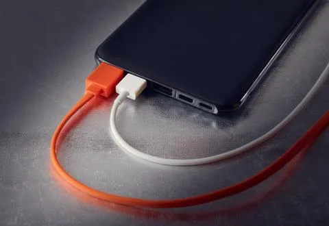 Power bank for charging mobile devices and two USB cables Stock Photos