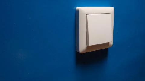 Power button on a blue wall - side view Stock Photos