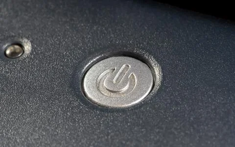 Power button on a laptop computer, powering on a simple electrical appliance  Stock Photos