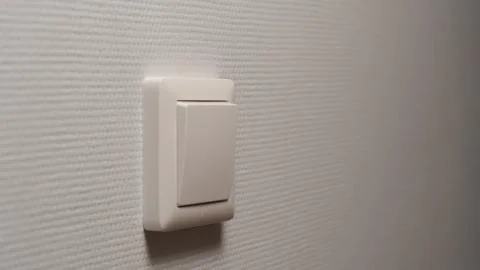 Power button on a light-grey wall 写真素材