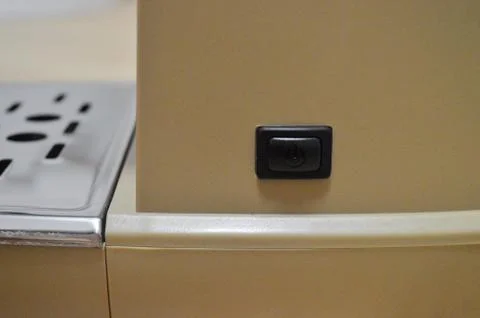 The power button on a modern beige coffee Stock Photos