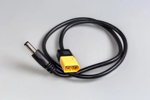 Power cable-adapter with flat and coaxial connectors on edges Stock Photos
