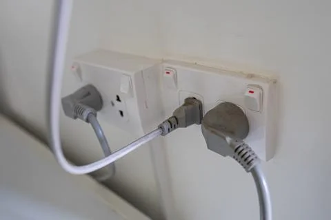 Power cable electric plug on wall at house. Stock Photos