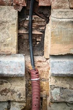 Power cable embedded in the wall, renovation of the house's utilities Stock Photos