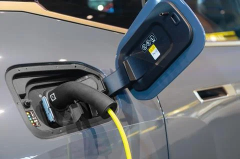 Power cable pump plug in charging power to electric vehicle EV car Stock Photos