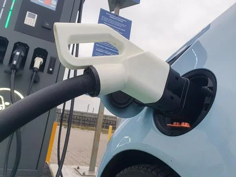 Power cable pump plug in charging power to electric vehicle EV car with mod.. Stock Photos