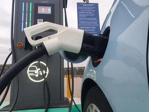 Power cable pump plug in charging power to electric vehicle EV car with mod.. Stock Photos