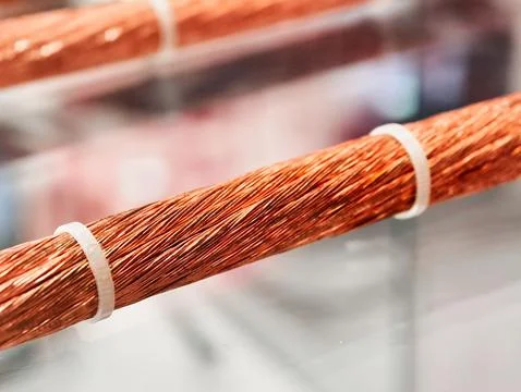 Power cables coiled expertly, showcasing intricate craftsmanship in electrical Stock Photos