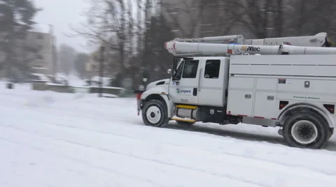 Power company truck passes in snowstorm, stock footage Stock Footage