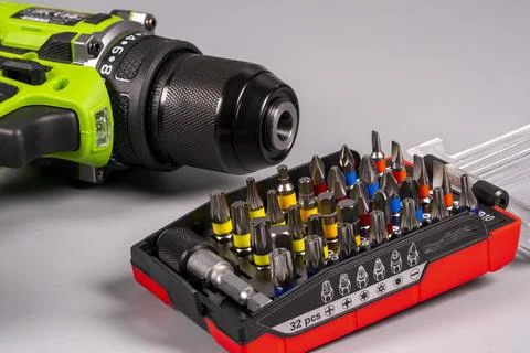 Power drill and tool set on a plain surface for repair tasks Stock Photos