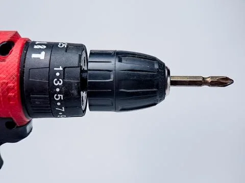 A power drill with a Phillips head bit extends, presented on a soft, diffus.. Stock Photos