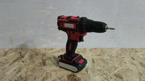 Power drill on a wooden table close-up. Continuous Electric Tools Video stock 321390402