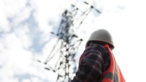 A power engineer inspects a high-voltage power line and records data. Stock Footage 239468525