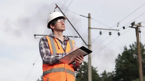 The power engineer inspects the high-voltage power line and records the data. Stock Footage 242162806