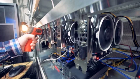 Power of graphic cards is being checked with power meter during bitcoin mining Stock Footage 88547207