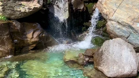 The power of a hidden waterfall in the deep cold blue water on the Italian Al Stock Footage 160834365