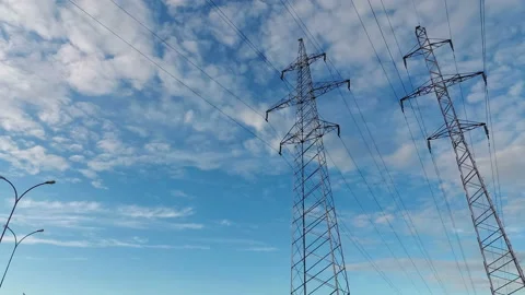 Power line against a cloudy sky .The camcorder rotates from left to right. Time  Stock Footage 112325023