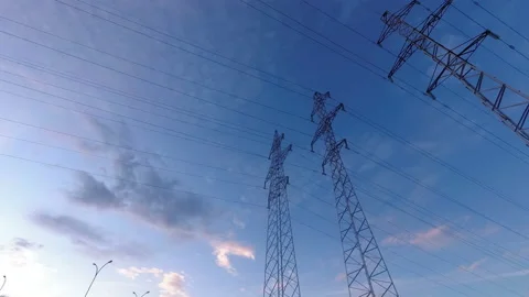 Power line against a cloudy sky .The camcorder rotates from left to right. Time  Stock Footage 112329209