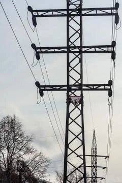 Power line is on the blue sky background. Vertical photo Foto stock
