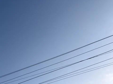 Power line, cables pattern on blue clear sky. Stock Photos