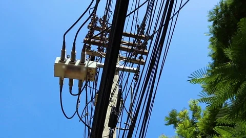 Power line on electric pole, highly dangerous under blue sky Stock Footage 117928668