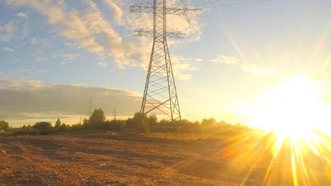 Power line in field at summer sunset timelapse Stock Footage 81606074
