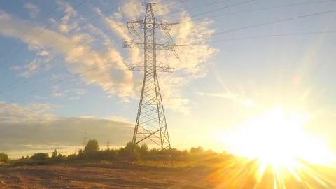 Power line in a field at sunset timelapse Stock Footage 81607319