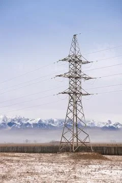 Power line in fields on mountains background Stock Photos
